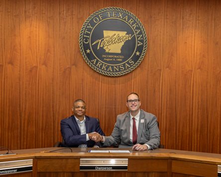 Photo: Texarkana Arkansas City Manager Robert Thompson (left) and A&M-Texarkana President Dr. Ross Alexander (right) sign a partnership agreement allowing full-time Texarkana Arkansas city employees to take courses at the university at a discounted rate.