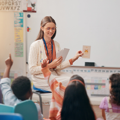 Student raising hand in classroom.