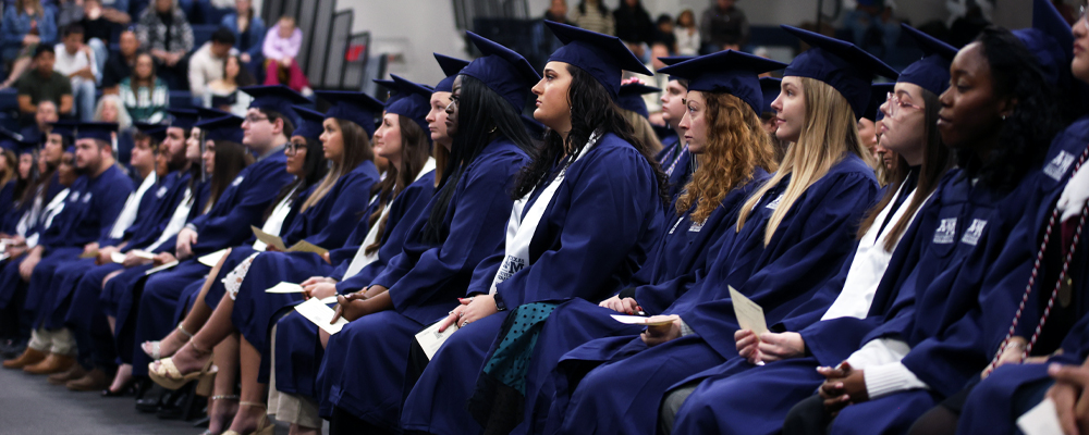 Students in regalia on campus