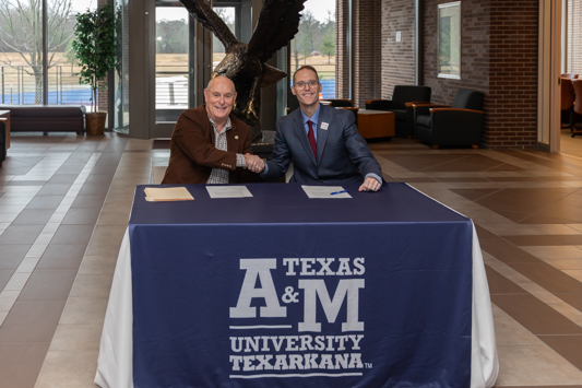 Red River Lumber CEO Mike Craven (left) and A&M-Texarkana President Dr. Ross Alexander sign a new partnership agreement between the company and the university. The agreement allows Red River Lumber employees to receive tuition savings on courses taken at the university.