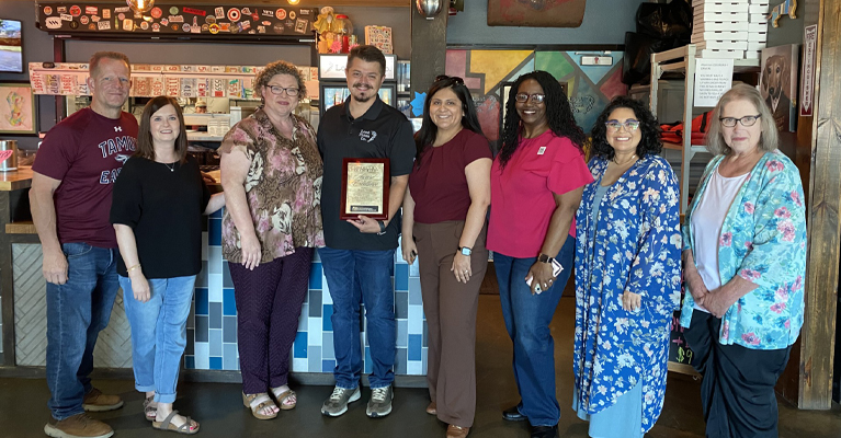 Members of the PECE team present Donnie Spriggs with the 2025 Community Leadership Excellence Award. Pictured in the photo (from left) are Jeremy Meunier, Tina Reed, Dr. Lisa Myers, Donnie Spriggs, Dr. Jennifer Davis, LaQuetta White, Kristina Rivas, and Katheryn Hartshorn.