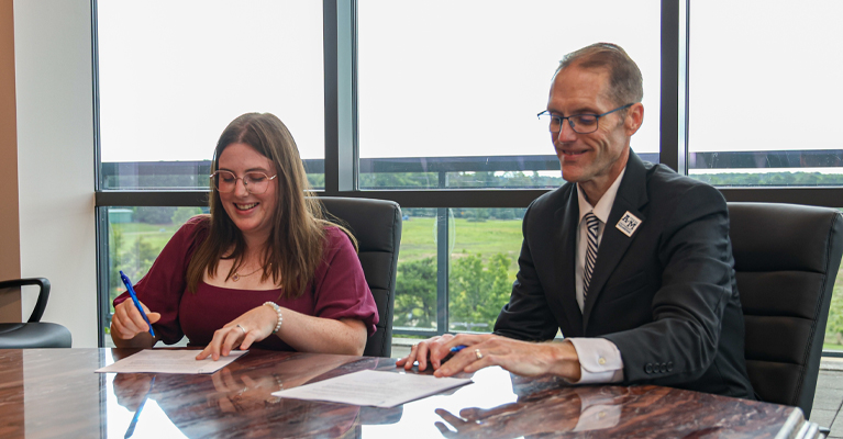 Jackie Whittington, Executive Director of the Literacy Council of Bowie and Miller Counties and Dr. Ross Alexander, President of A&M-Texarkana, sign a partnership between the local non-profit organization and the university. Full-time employees of the Literacy Center will be able to receive discounted tuition to courses at A&M-Texarkana.