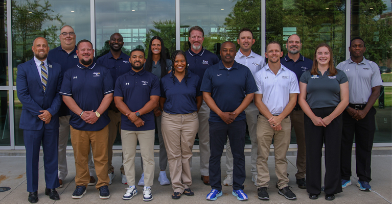 Texas A&M University-Texarkana Athletics Staff (front row, from left) Athletic Director Ryan Wall, Chase Brewster, Darion Brown, Fachaitte Kinslow, David Lawrence, Jr., Michael Flanagan, Camry Dillie. (Back row, from left) Brian Nelson, Deacon Jones, Madeleine Halford, Tony McKnight, Ryan Huntze, Rick Allen, Don Koontz.