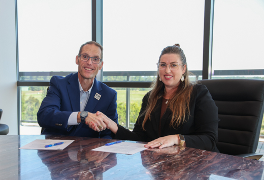 Texas A&M University-Texarkana President Dr. Ross Alexander (left) and Texarkana Resources CEO Jennifer Lewis sign a memorandum of understanding forming a new partnership between the University and the non-profit agency. The new partnership grants discounted tuition rates to Texarkana Resources employees for classwork at the University.