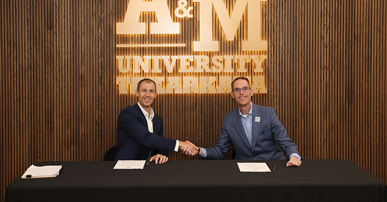 CDI Contractors CEO Mike Preston (left) and A&M-Texarkana President Dr. Ross Alexander shake hands after signing a memorandum of understanding between the Little Rock-based construction company and the University on June 11, 2026.